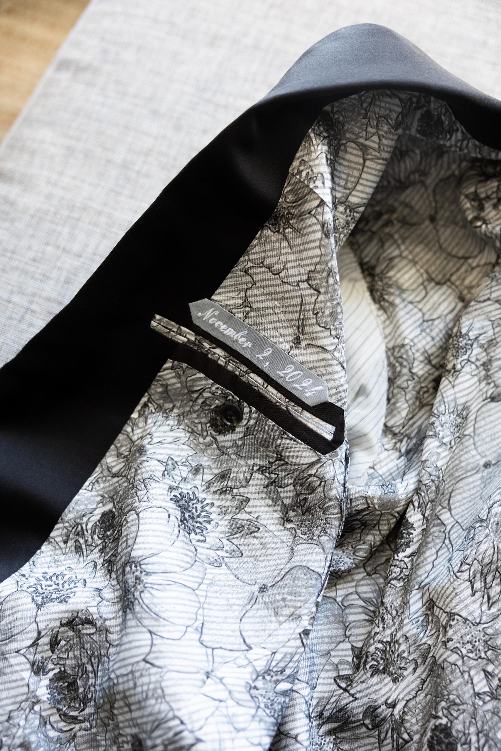 Custom lining and date inside of a bespoke tuxedo jacket, suit jacket